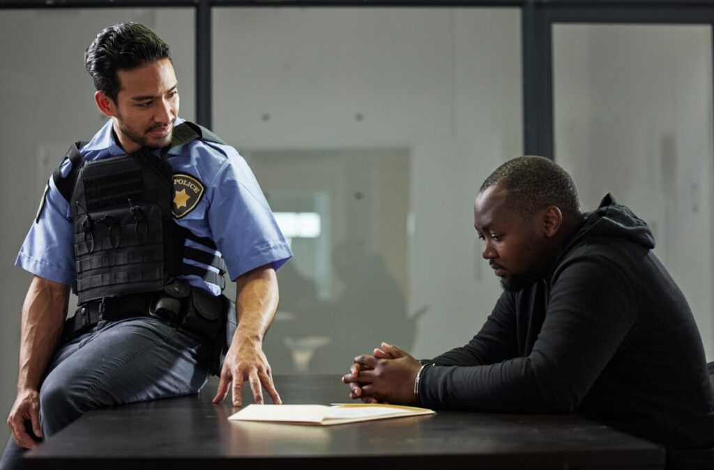 Police, interrogation and black man, suspect or criminal investigation for crime at station. Africa