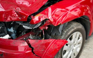 Red Car crash background. Front of red car get damaged by accident on the road