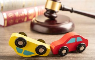 Hammer gavel judge with car vehicle accident, insurance coverage claim lawsuit court case.