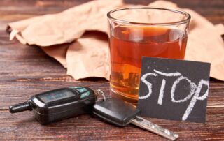 Alcohol beverage, car keys, note