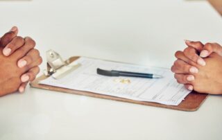 Couple hand sign legal divorce documents, contract or paper deal in a lawyer office with ring place