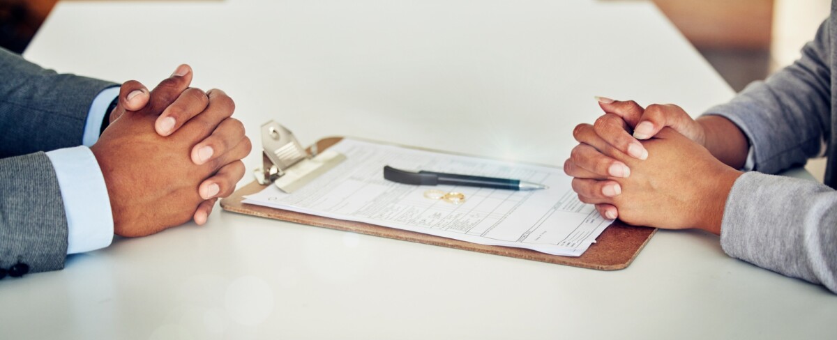 Couple hand sign legal divorce documents, contract or paper deal in a lawyer office with ring place
