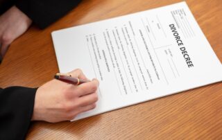 DIVORCE DECREE. Woman sign the paper. Lawyer, notary office, close up above view