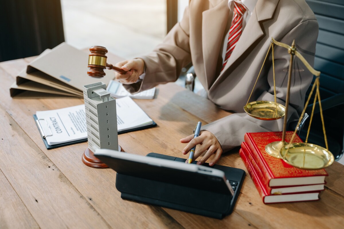 Real Estate Lawyer And House Foreclosure Law. House model, hammer judge gavel on table