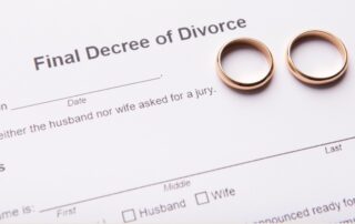 Two golden wedding rings on final divorce decree document