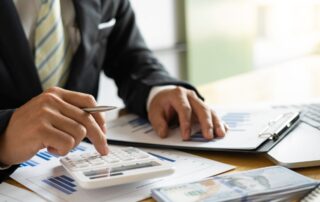 Businessman accountant or financial expert analyze business report graph and finance chart at the co