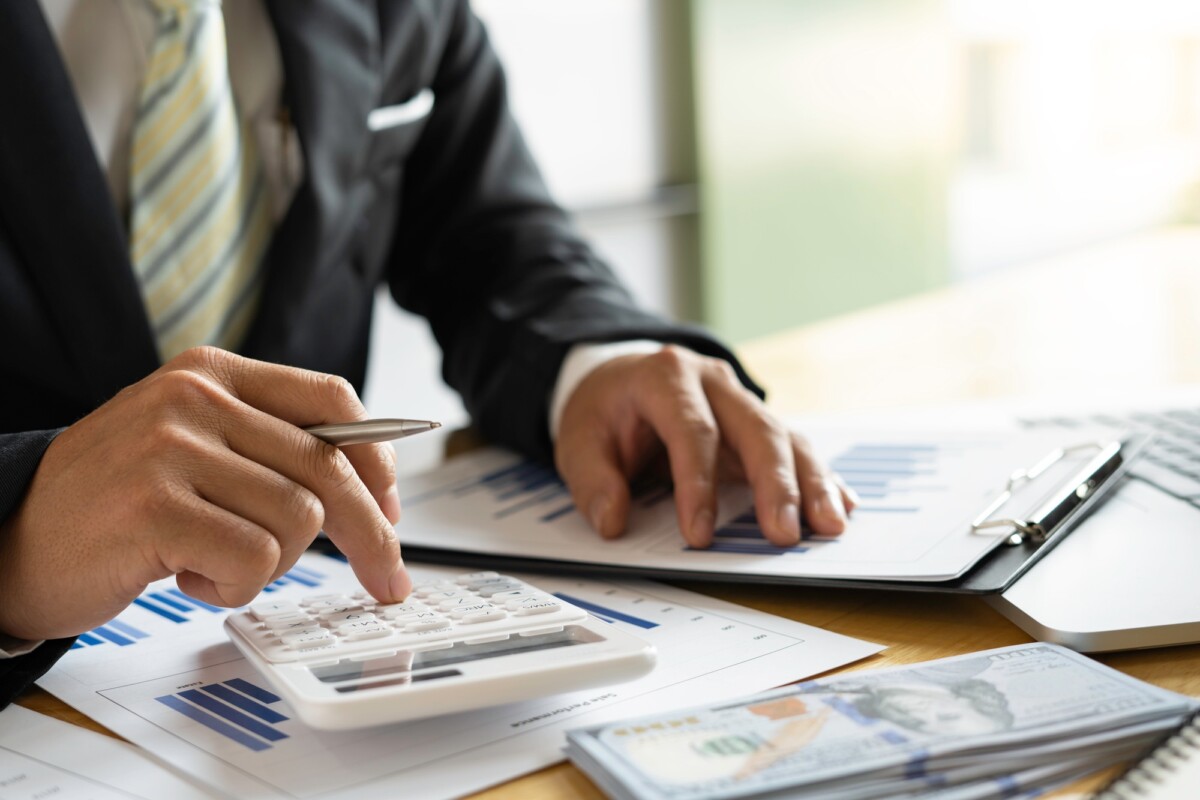 Businessman accountant or financial expert analyze business report graph and finance chart at the co