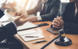 Businessman and lawyer discuss lawsuits in the office.