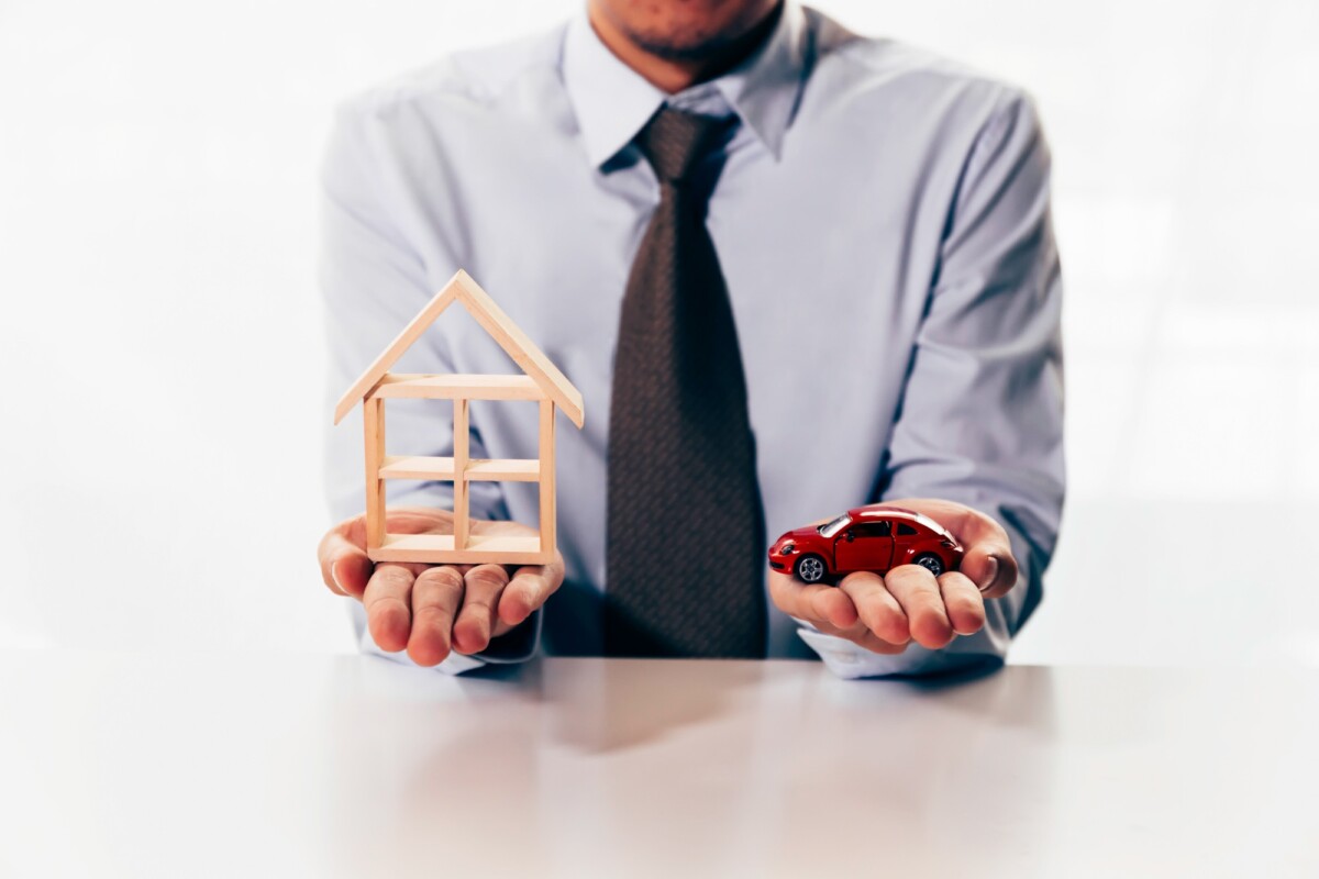 businessman in dilemma of planning to choose between spending either house or car first