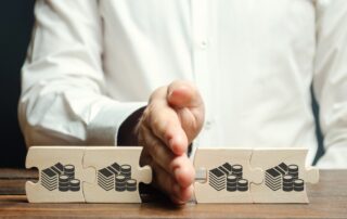 Businessman separates the wooden puzzle with a picture of money