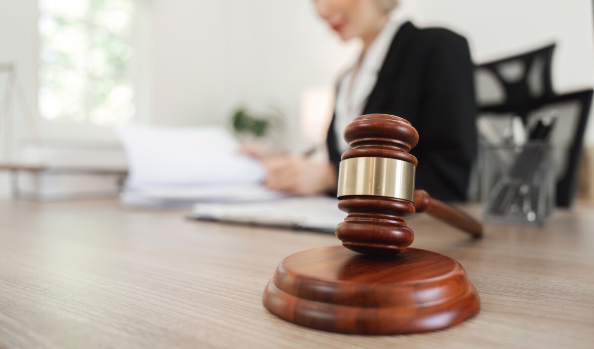 Female Lawyer Reviewing Contract Documents for Legal Case in Modern Office Setting