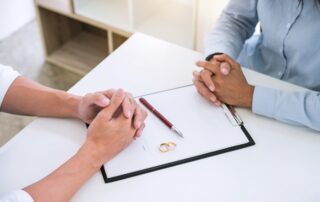 Husband and wife are reading divorce agreement and signing decree of divorce (dissolution or