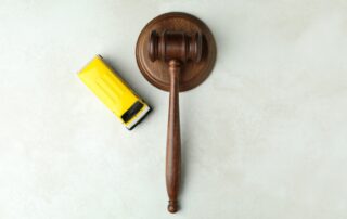 Judge gavel and toy car on white textured background