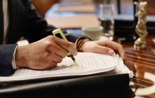 Man Overviewing Document and Highlighting Words in It