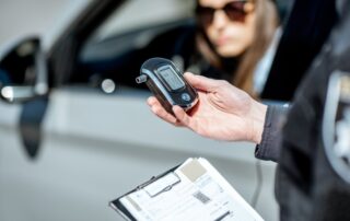 Policeman with alcotest device