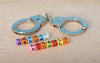 Sexual Assault Awareness: Justice and Accountability Represented by Handcuffs and Beads
