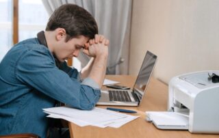 Stressed caucasian guy thinking about solutions in his home office