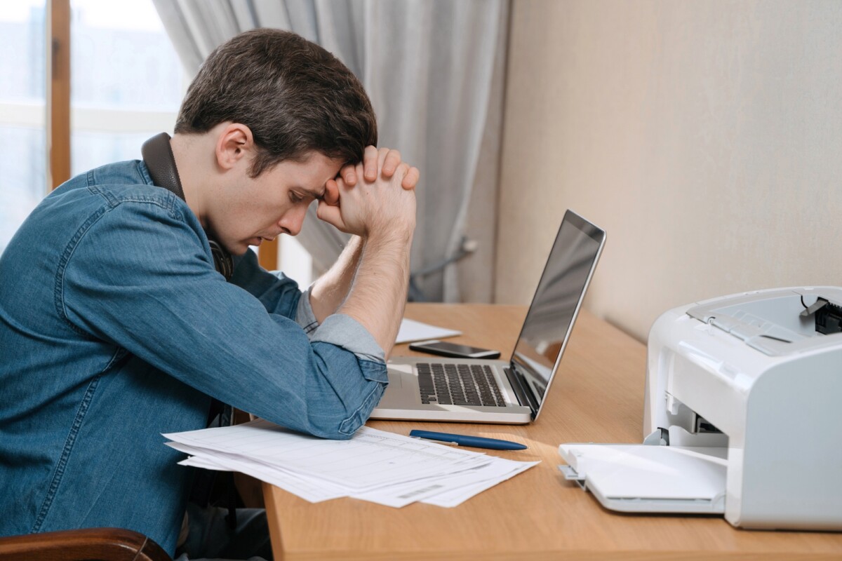 Stressed caucasian guy thinking about solutions in his home office