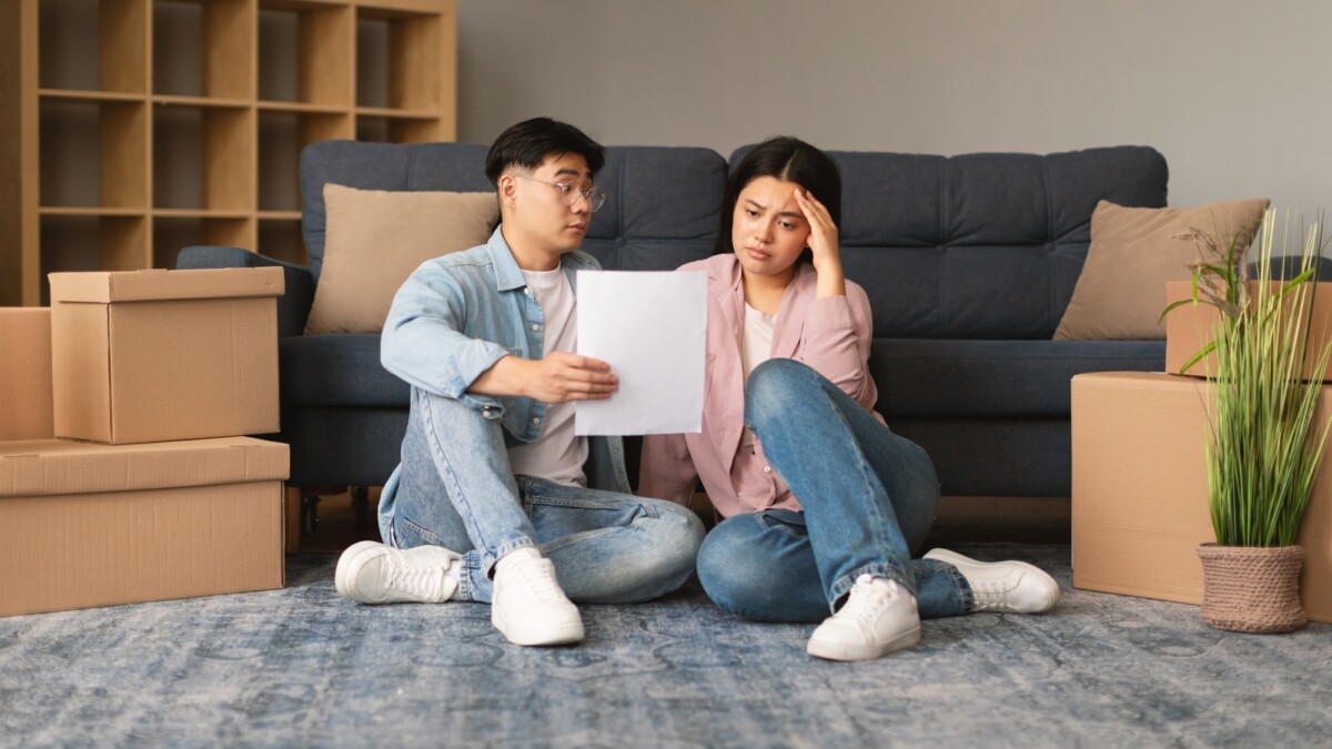 Unhappy Asian Family Couple Having Issue With Mortgage Debt Indoor
